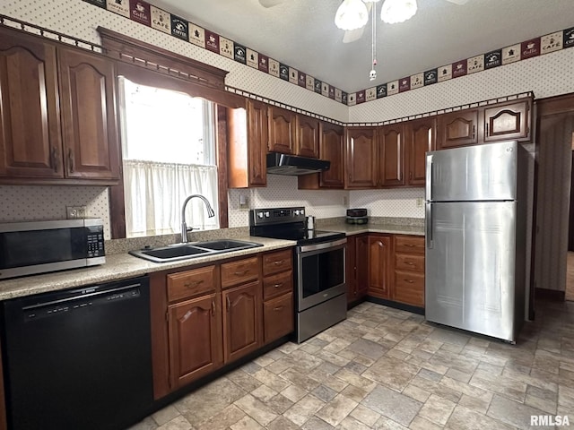 kitchen featuring sink, dark brown cabinets, a textured ceiling, appliances with stainless steel finishes, and decorative backsplash