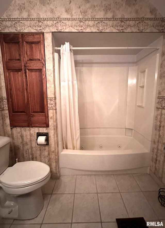 bathroom featuring shower / bathtub combination with curtain, tile patterned floors, and toilet