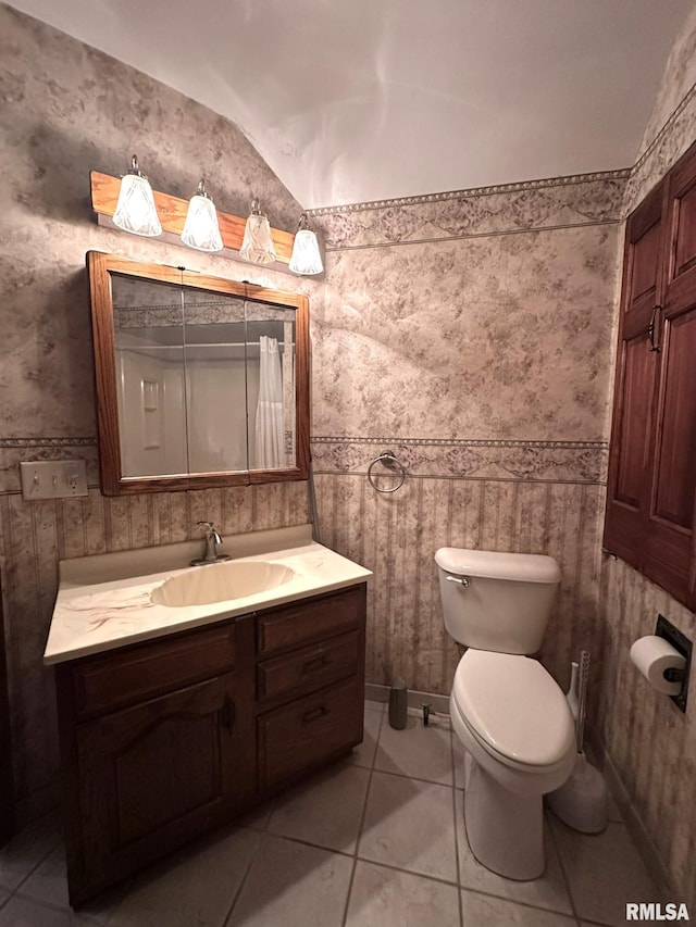 bathroom featuring tile patterned floors, vanity, and toilet