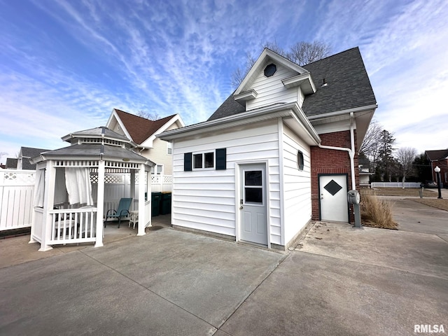 view of side of home featuring a gazebo and a patio area