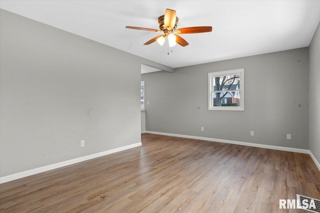 spare room with ceiling fan and light wood-type flooring