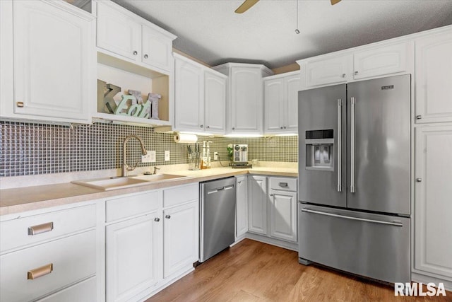 kitchen featuring sink, white cabinets, and appliances with stainless steel finishes