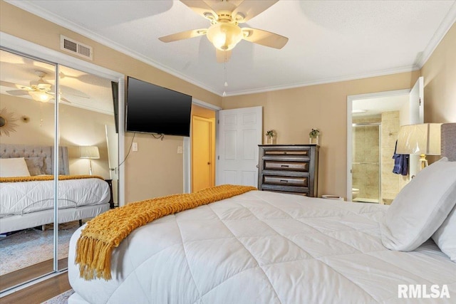 bedroom with ceiling fan, ornamental molding, ensuite bath, and a closet