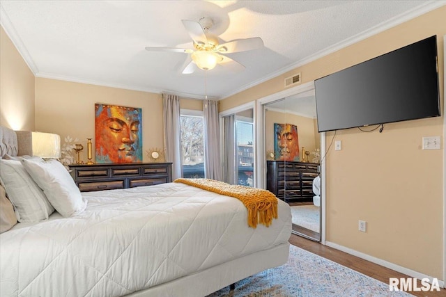 bedroom featuring hardwood / wood-style flooring, ceiling fan, and ornamental molding