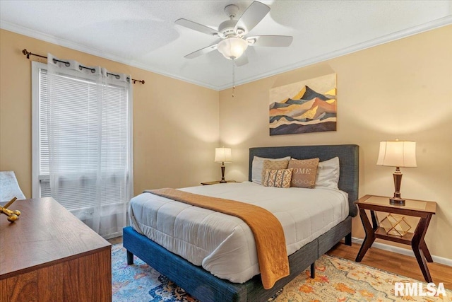 bedroom featuring ornamental molding, ceiling fan, and light hardwood / wood-style flooring