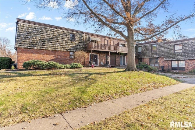 back of property featuring a deck and a lawn