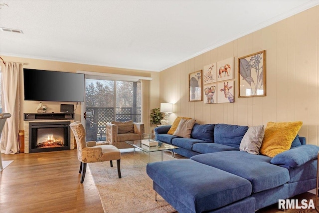 living room featuring crown molding and wood-type flooring