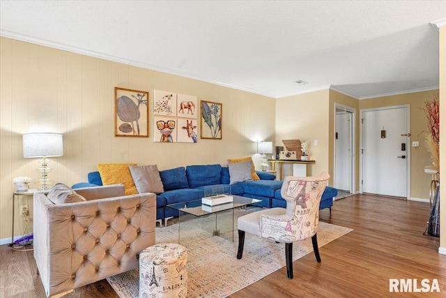 living room featuring ornamental molding, hardwood / wood-style floors, and a textured ceiling