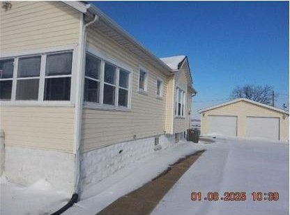 view of property exterior featuring an outbuilding and a garage