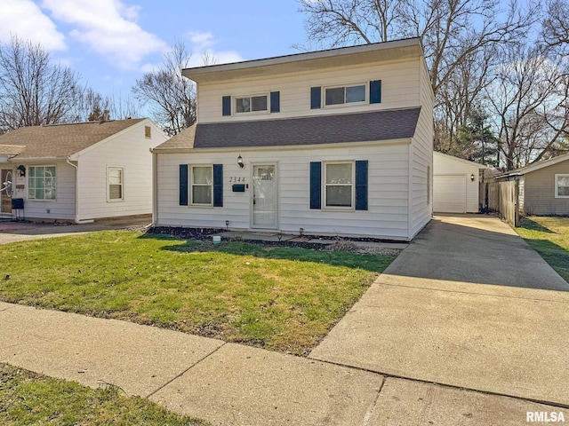 view of front of property with an outbuilding, a garage, and a front lawn