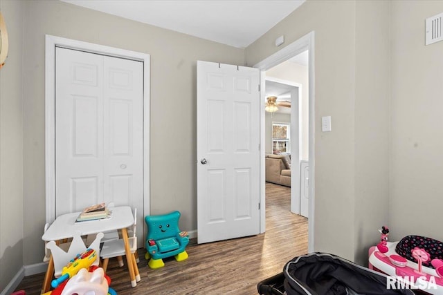 bedroom with wood-type flooring and a closet