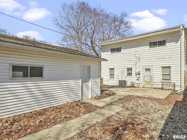 rear view of house with central AC unit and a patio area