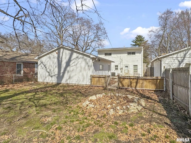 back of house with a lawn