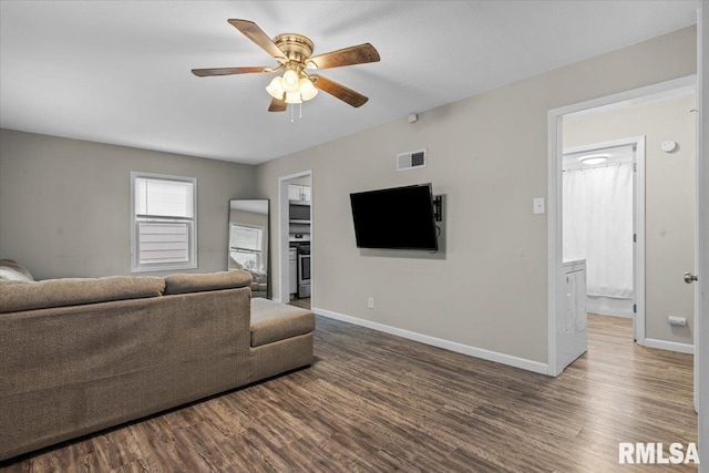 living room featuring ceiling fan and wood-type flooring