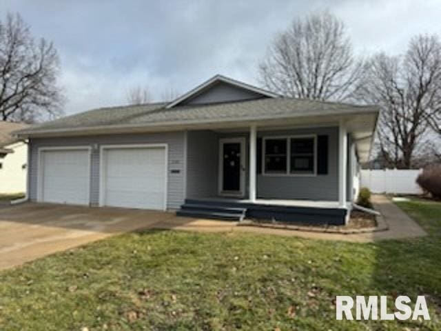 view of front of home featuring a garage and a front lawn