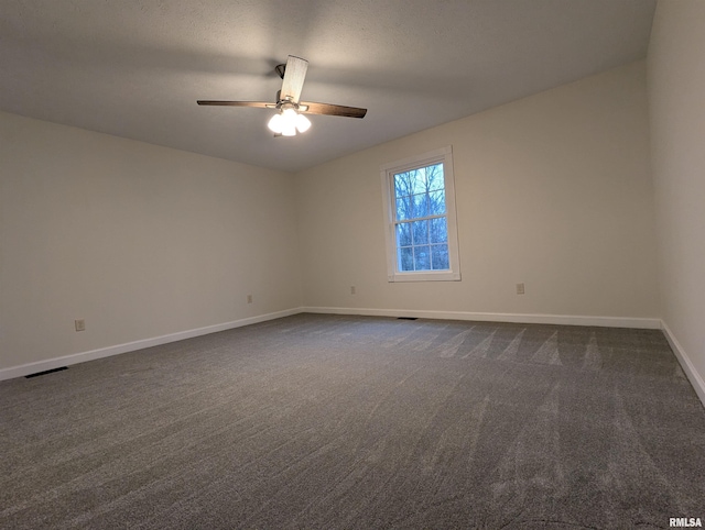 carpeted empty room with a textured ceiling and ceiling fan