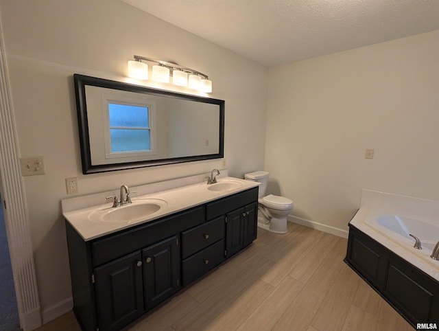 bathroom with toilet, vanity, a bath, and hardwood / wood-style floors