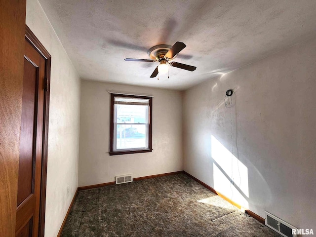 spare room featuring ceiling fan, carpet flooring, and a textured ceiling