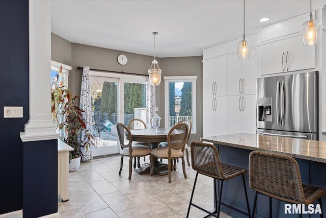 tiled dining area featuring ornate columns