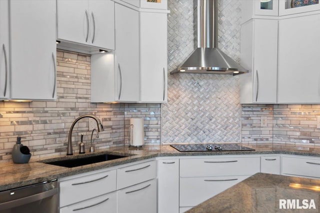 kitchen featuring white cabinets, dishwasher, sink, and wall chimney exhaust hood