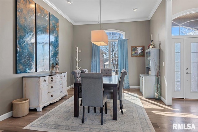 dining area featuring crown molding and hardwood / wood-style floors