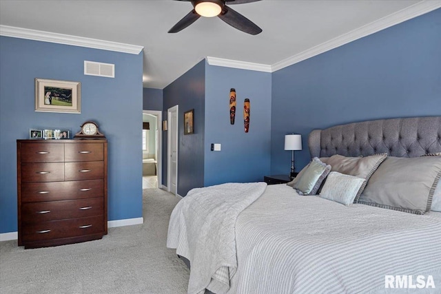 carpeted bedroom with ceiling fan, ornamental molding, and ensuite bath