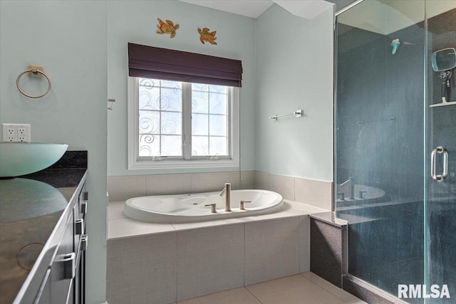 bathroom with tile patterned flooring, vanity, and separate shower and tub