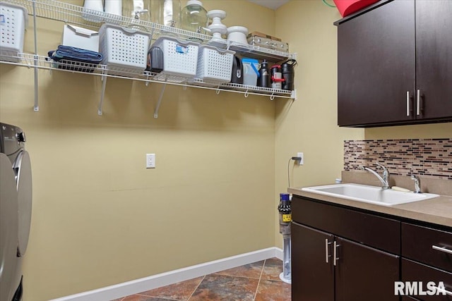 laundry area featuring cabinets, sink, and washer and dryer