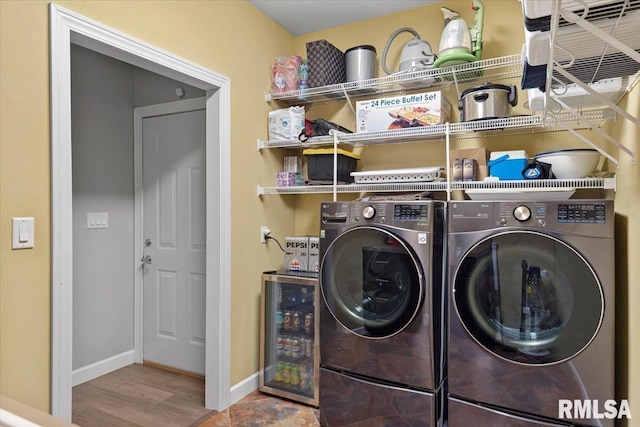 laundry area with wood-type flooring, wine cooler, and washer and clothes dryer