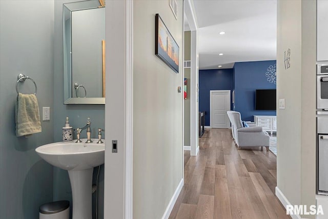 bathroom with wood-type flooring