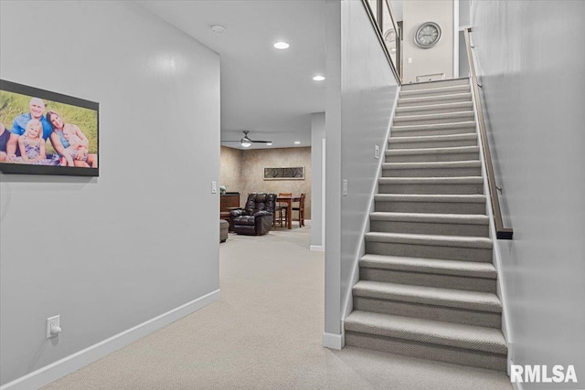 staircase with carpet flooring and ceiling fan