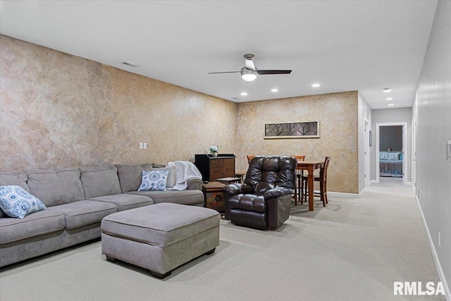 carpeted living room featuring ceiling fan