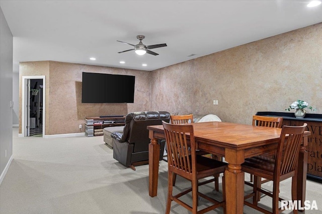 dining room with ceiling fan and carpet