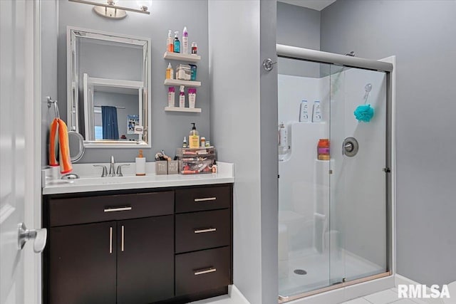 bathroom featuring vanity and a shower with shower door