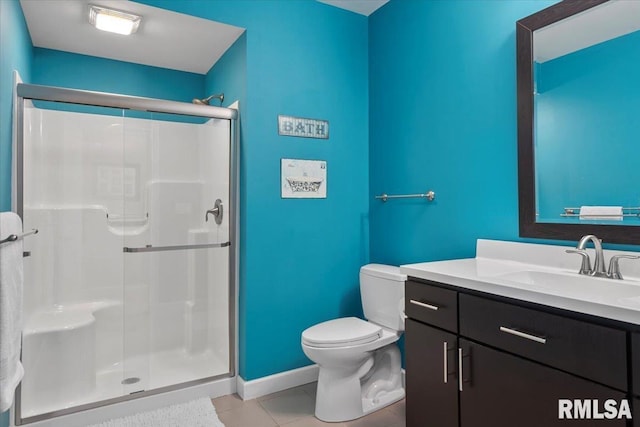 bathroom with walk in shower, vanity, toilet, and tile patterned flooring