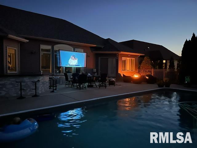 view of pool with a patio and exterior bar