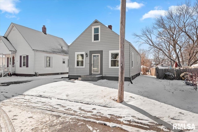 view of snow covered back of property