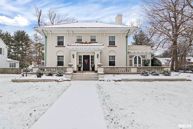 view of snow covered rear of property