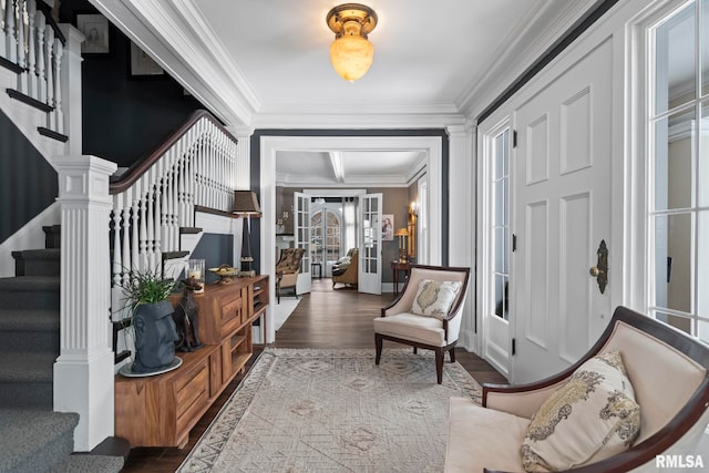 foyer entrance featuring hardwood / wood-style flooring and ornamental molding