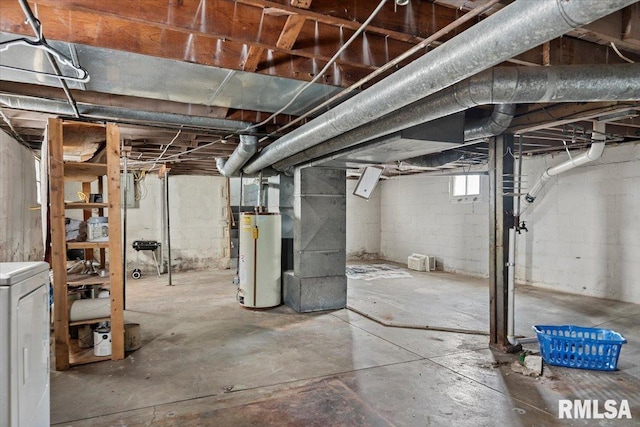 basement featuring gas water heater and washer / dryer