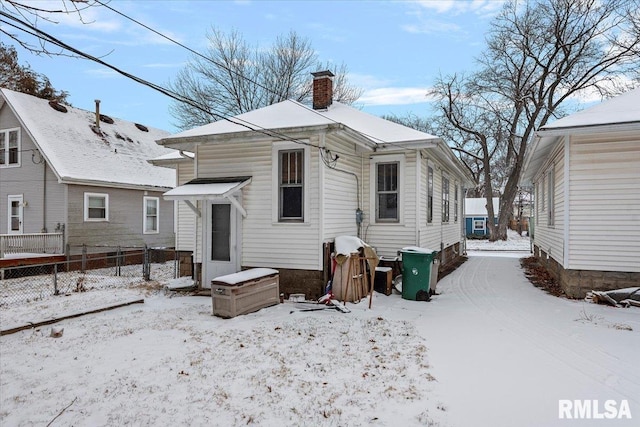 view of snow covered rear of property