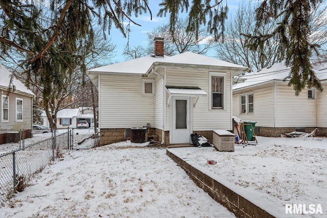 snow covered property featuring central AC unit