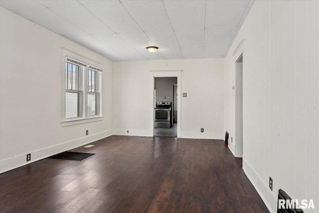 spare room featuring dark hardwood / wood-style flooring