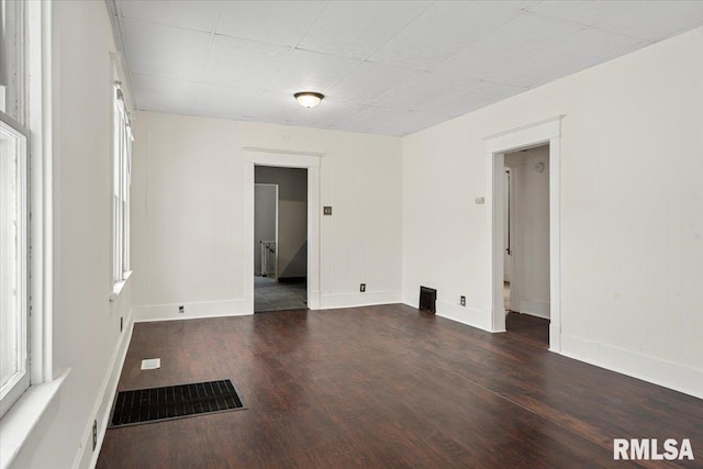 unfurnished room featuring dark hardwood / wood-style flooring