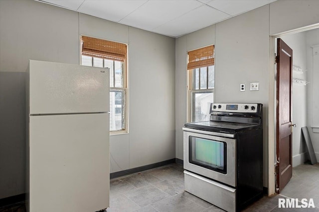 kitchen with white refrigerator and stainless steel electric range