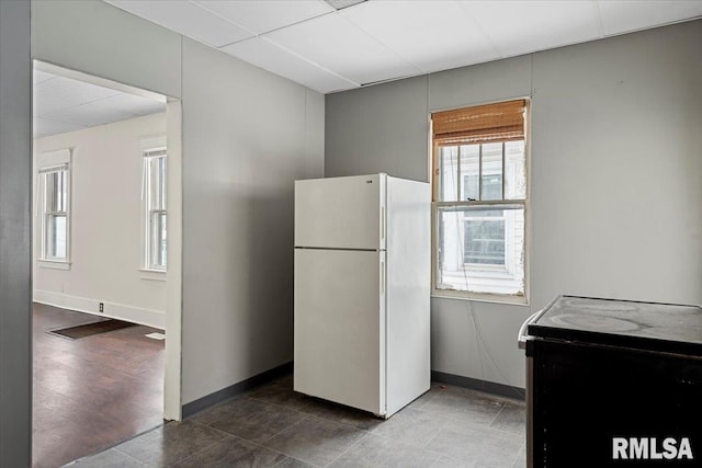 kitchen featuring black electric range oven and white fridge