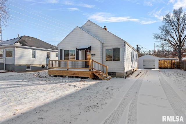 view of front of house with a garage, an outbuilding, and a deck