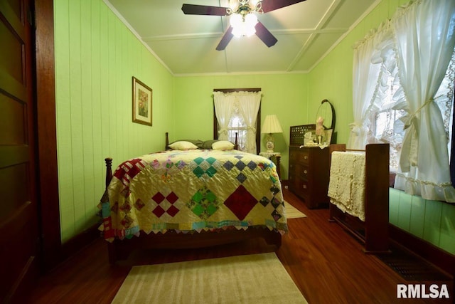 bedroom featuring multiple windows, ornamental molding, and dark hardwood / wood-style floors