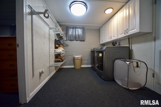 laundry room featuring cabinets, washing machine and dryer, and dark carpet