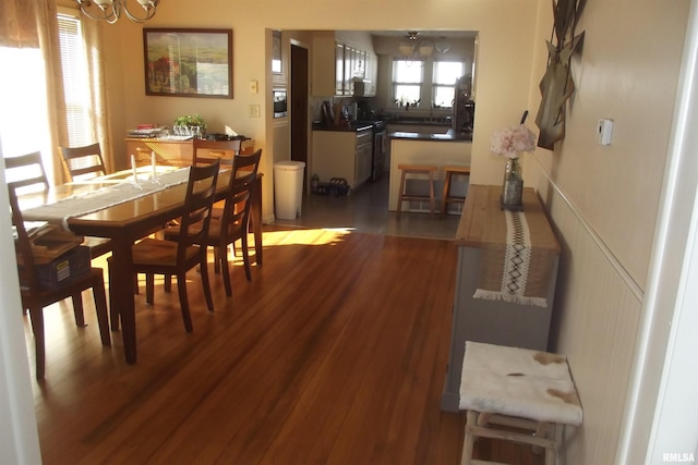 dining space with hardwood / wood-style flooring and a chandelier